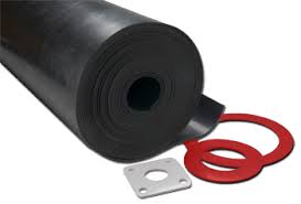 A roll of rubber sheet with gaskets cut from it in front: two red rings and a square flange plate. A roll of rubber sheet with gaskets cut from it in front: two red rings and a square flange plate.