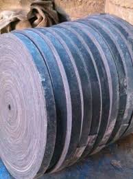 Rolls of balata flat belting stacked on their sides in the works. Rolls of balata flat belting stacked on their sides in the works.