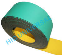 A roll of nylon core flat belting, green on one face and yellow on the other. A roll of nylon core flat belting, green on one face and yellow on the other.