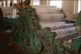 A flat belt driving a carding machine on a mill floor. A flat belt driving a carding machine on a mill floor.
