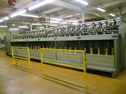 A row of spinning machines, each spindle driven by its own narrow tape. A row of spinning machines, each spindle driven by its own narrow tape.