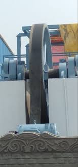 A wide flat belt driving the flywheel of a marble gang saw. A wide flat belt driving the flywheel of a marble gang saw.