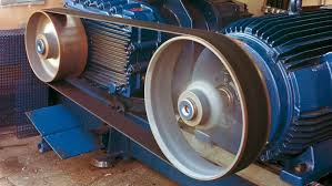 A flat belt running from an electric motor to the pulley of the machine it drives. A flat belt running from an electric motor to the pulley of the machine it drives.