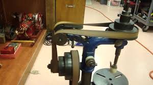 A flat belt driving a bench drilling machine in a workshop. A flat belt driving a bench drilling machine in a workshop.