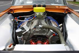 Radiator hoses routed across an engine bay under an open bonnet. Radiator hoses routed across an engine bay under an open bonnet.