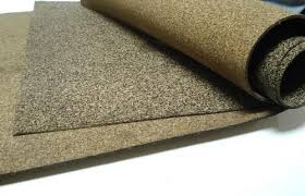 A sheet of nitrile rubberised cork curled back, the cork granules visible across its face. A sheet of nitrile rubberised cork curled back, the cork granules visible across its face.