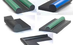 Moulded rubber packing profiles in black, green and blue, laid out to show their sections. Moulded rubber packing profiles in black, green and blue, laid out to show their sections.