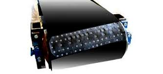 A fastened belt joint passing over a conveyor pulley, the row of plates running across the belt. A fastened belt joint passing over a conveyor pulley, the row of plates running across the belt.