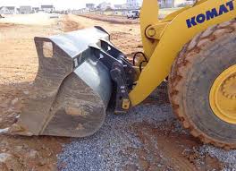 The quick coupler on the arm of a loading shovel, with its bucket on the ground beside it. The quick coupler on the arm of a loading shovel, with its bucket on the ground beside it.