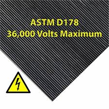 A corner of finely ribbed matting marked ASTM D178, 36,000 volts maximum, beside a high voltage warning symbol.