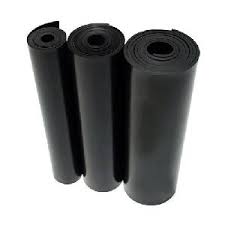 Three rolls of black electrical matting standing together.