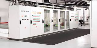 Matting laid down the aisle of a switchroom between two rows of high tension panels.