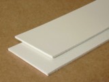 Two cut strips of white food grade PVC belt lying one across the other. Two cut strips of white food grade PVC belt lying one across the other.