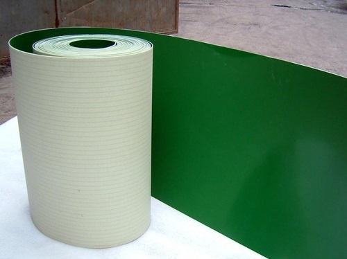 A roll of PVC belting, green on its top face and pale on the fabric underside. A roll of PVC belting, green on its top face and pale on the fabric underside.