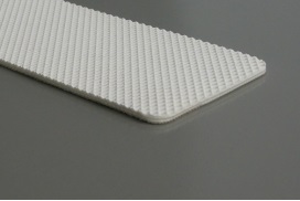 A cut piece of white food grade belt, a fine diamond pattern across its face. A cut piece of white food grade belt, a fine diamond pattern across its face.